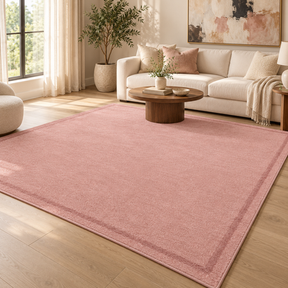 Blush Pink Plain Hand Tufted Rug – Subtle Single Border styled in a decorated living room with sofa