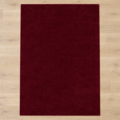 Totally plain burgundy hand tufted rug, no border