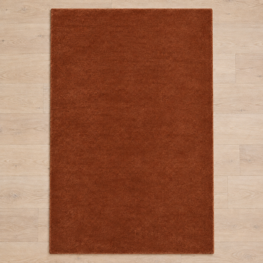 Totally plain rust brown hand tufted rug, no border