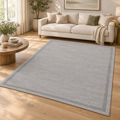 Light Grey Plain Hand Tufted Rug – Subtle Single Border styled in a decorated living room with sofa