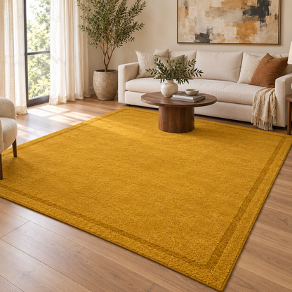 Mustard Plain Hand Tufted Rug – Subtle Single Border styled in a decorated living room with sofa