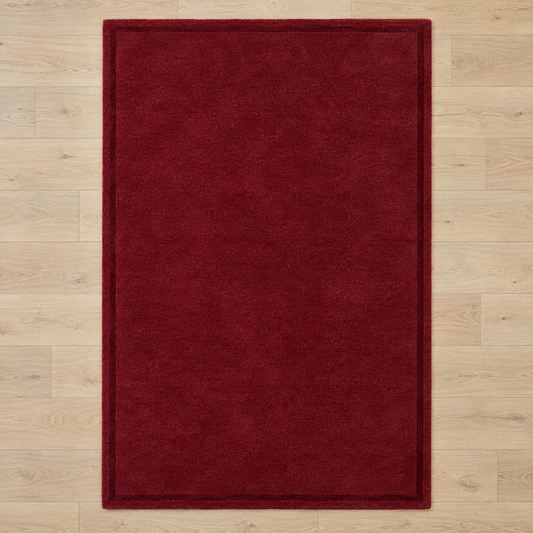 Burgundy plain hand tufted single border rug