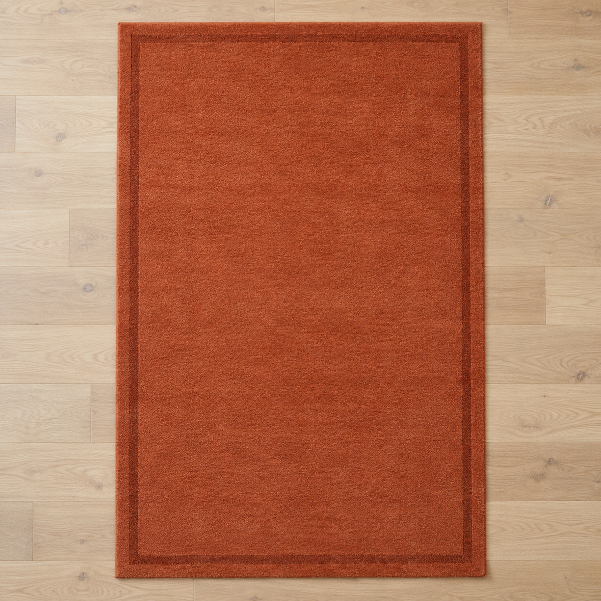 Terracotta plain hand tufted single border rug
