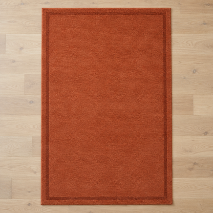 Terracotta plain hand tufted single border rug
