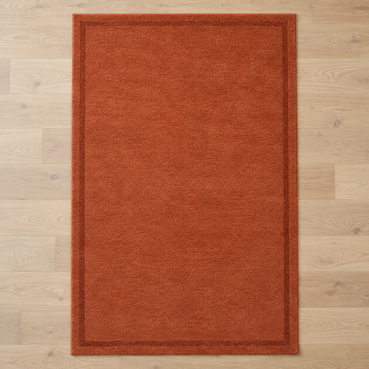 Terracotta plain hand tufted single border rug